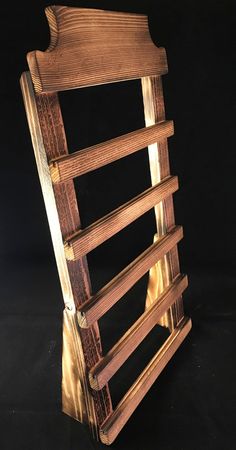 a wooden chair that is made out of some kind of wood and has four slats on it