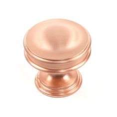 an antique brass cabinet knob on a white background