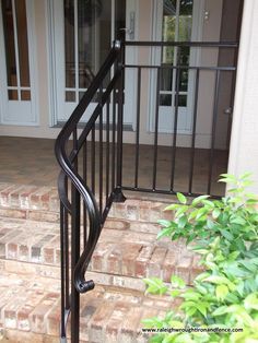 a black iron stair rail on the outside of a house