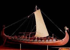 a wooden model of a boat on display