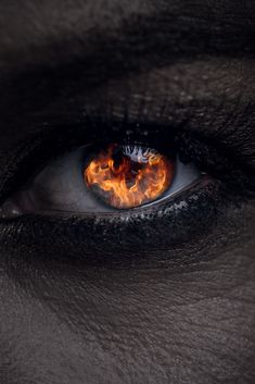 an eye with flames in the center and black skin on it's outside, as seen from above