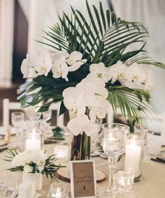 white flowers and candles are on the table