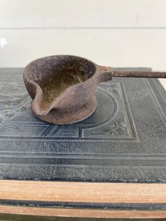 an old wooden spoon sitting on top of a book