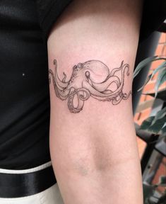 an octopus tattoo on the arm