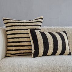 two black and white striped pillows on a couch