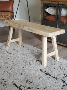 a wooden bench sitting on top of a rug