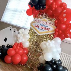 balloons and streamers decorate the table at a las vegas themed birthday party