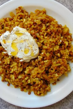 a white plate topped with rice and an egg