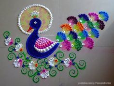 an artistically designed wall hanging with peacocks and flowers