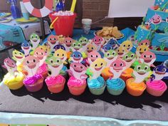 there are many cupcakes that have been placed on the table for children to eat