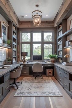 a home office with built in desks and bookcases on the far wall