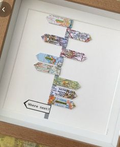 a wooden frame holding a map and some paper cut out of it's sides