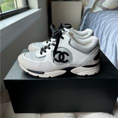 Super Stylish 2022 Spring Summer Edition Sneakers. Comes With Original Box And Dust Bags. White With Grey And Black And Silver Lining. Size 36. Excellent Condition. Worn Twice. Small Mark Inside One Of The Tongues That Is Not Noticeable From The Outside. Chanel Sneakers 2022, Chanel Sneakers, Silver Lining, Chanel Shoes, Black And Silver, Sneakers White, Womens Shoes Sneakers, Original Box, Dust Bag