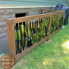 there is a wooden fence with many bottles in the bottom and bottom, as well as an open door