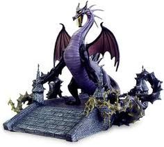 a statue of a dragon on top of a roof with bats and skulls around it