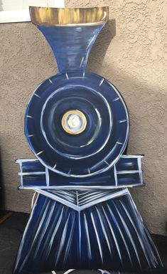 a painting of a blue train engine on the side of a building