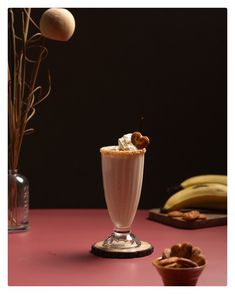 there is a drink with whipped cream and nuts on the table