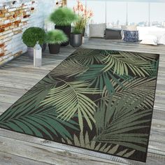 a large area rug with palm leaves on it