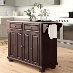 a kitchen island with two wine glasses on it