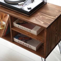 a record player sitting on top of a wooden table