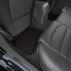 the interior of a car with black and white pictures on the front floor mats,