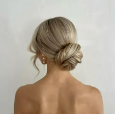 a woman with blonde hair in a low bun