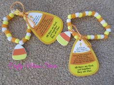 two colorful bracelets with an orange, yellow and white beaded cross on them