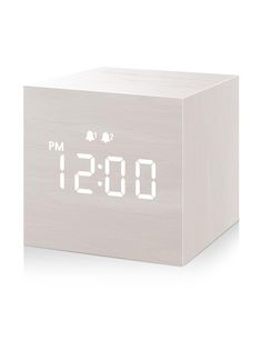 an alarm clock with the time displayed on it's display panel, in front of a white background