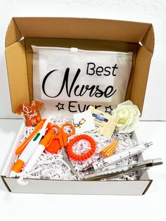 the best nurse ever box is packed with scissors and other medical supplies, including an orange pair of scissors