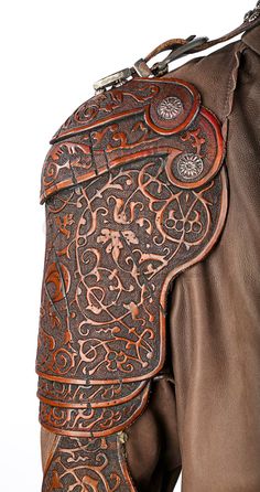 the back end of a horse's saddle with intricately decorated leather and stitching