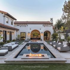 an outdoor fire pit in the middle of a patio