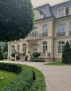 a large house with lots of windows and bushes