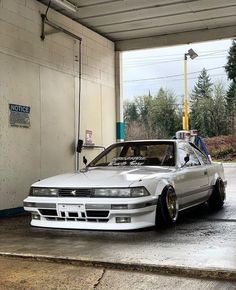 a white car is parked in a garage