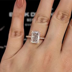 a woman's hand with a diamond ring on it