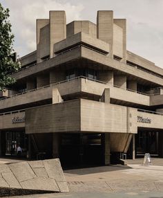 an architectural building with people walking around it