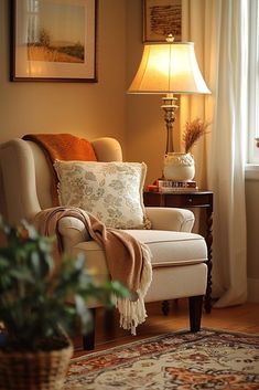 a living room with a chair, lamp and pictures on the wall in it's corner