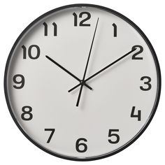 a white clock with black hands and numbers