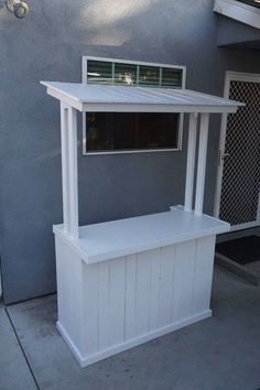 a small white bar on the side of a building