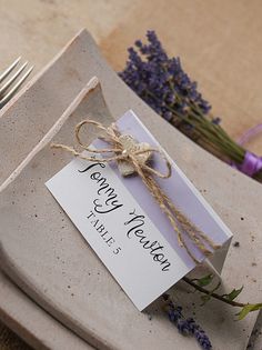 a table setting with flowers and place cards