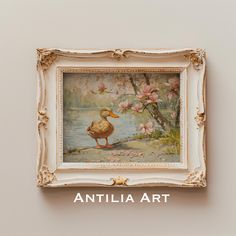 a painting hanging on the side of a wall next to a white frame with an image of a duck