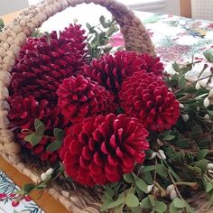 a basket filled with red flowers on top of a table