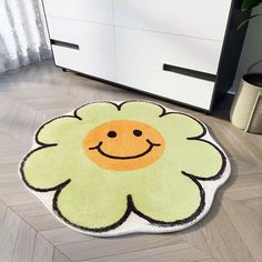 a rug with a smiling flower on it