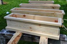 several wooden planters sitting on top of a bench