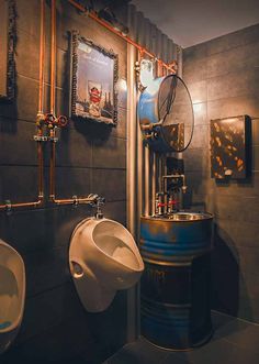 two urinals and a sink in a bathroom