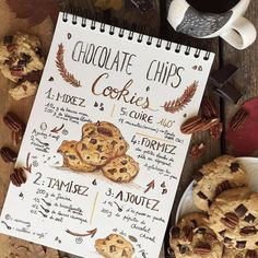 a recipe book sitting on top of a table next to cookies