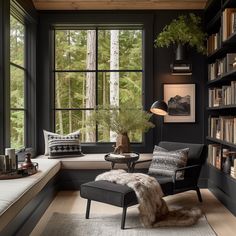 a living room filled with lots of furniture and bookshelves next to a window