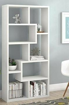 a white bookcase in a room with blue walls and a rug on the floor