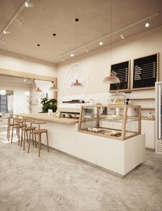 the inside of a restaurant with tables and stools in front of an open counter