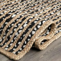 black and white rugs on the floor with wood floors in the background, close up