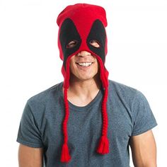 a man wearing a red and black knitted deadpool mask